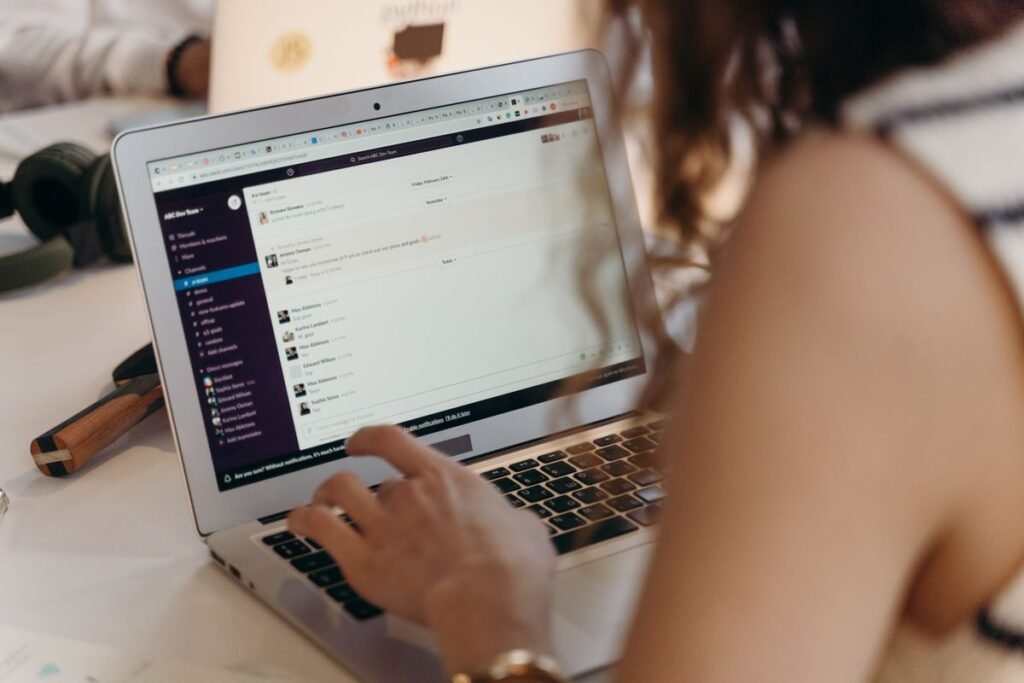 Businesswoman using Slack for team communication and AI meeting notes