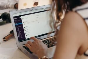 Businesswoman using Slack for team communication and AI meeting notes